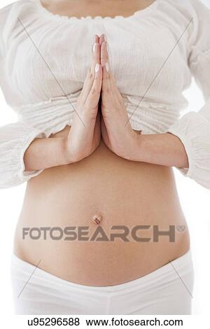 Stock Photo - Pregnant woman practicing yoga. Fotosearch