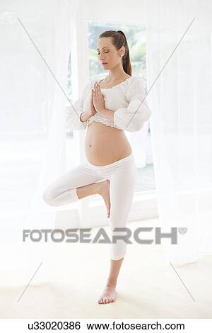 Pregnant woman practicing yoga View Large Photo Image Stock Photograph - Pregnant woman practicing yoga. Fotosearch