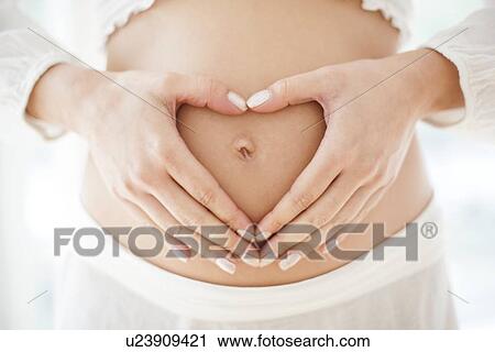 Stock Image - Pregnant woman's abdomen. Fotosearch