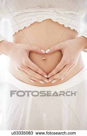 Stock Image - Pregnant woman's abdomen. Fotosearch