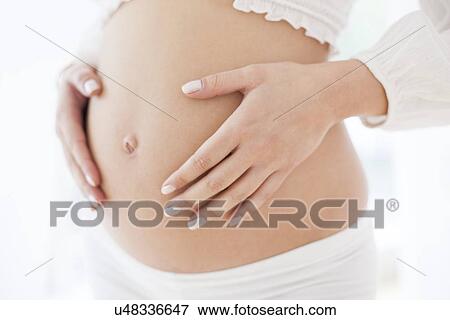 Pregnant woman's abdomen View Large Photo Image Stock Photo - Pregnant woman's abdomen. Fotosearch