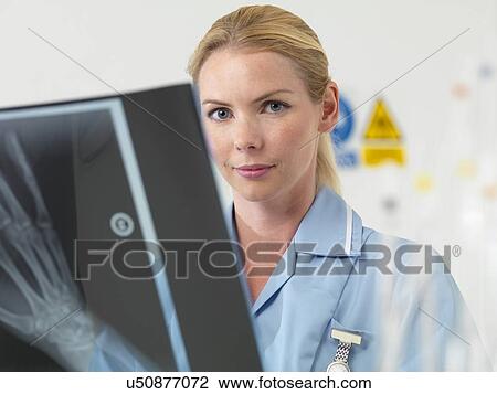 Stock Image - Radiologist examining an X-ray. Fotosearch