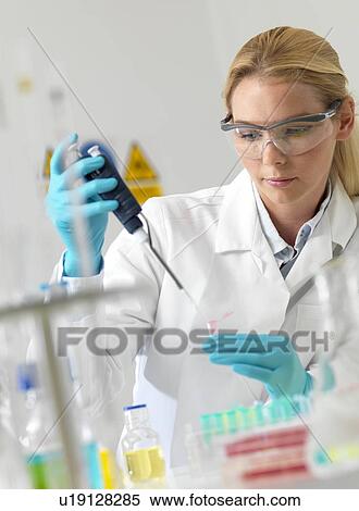 Researcher pipetting liquid View Large Photo Image Stock Photography - Researcher pipetting liquid. Fotosearch
