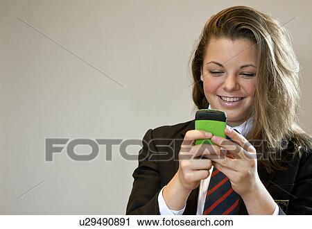 Stock Image - Teenager texting. Fotosearch