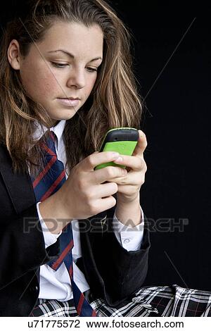 Stock Image - Teenager texting. Fotosearch