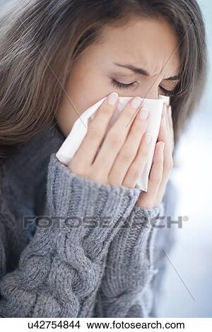Woman blowing her nose View Large Photo Image Picture - Woman blowing her nose. Fotosearch