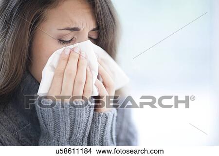 Woman blowing her nose View Large Photo Image Picture - Woman blowing her nose. Fotosearch