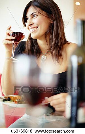 Stock Photo - Woman drinking wine with dinner. Fotosearch