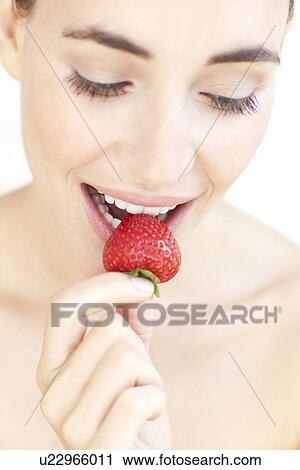 Woman eating a strawberry View Large Photo Image Stock Image - Woman eating a strawberry. Fotosearch
