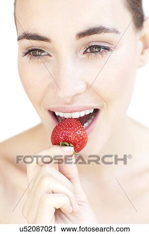 Woman eating a strawberry View Large Photo Image Stock Image - Woman eating a strawberry. Fotosearch