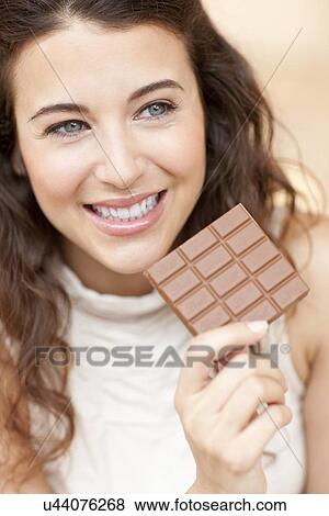 Stock Photo - Woman eating chocolate. Fotosearch