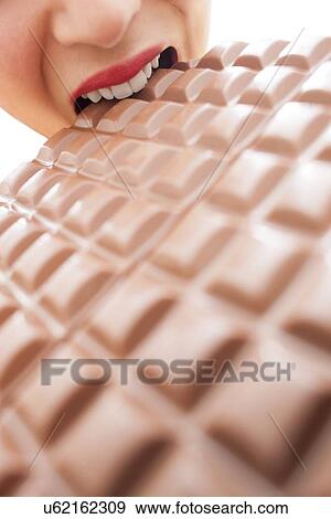 Stock Photo - Woman eating chocolate. Fotosearch