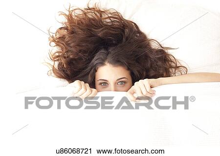 Woman hiding under a duvet View Large Photo Image Stock Image - Woman hiding under a duvet. Fotosearch