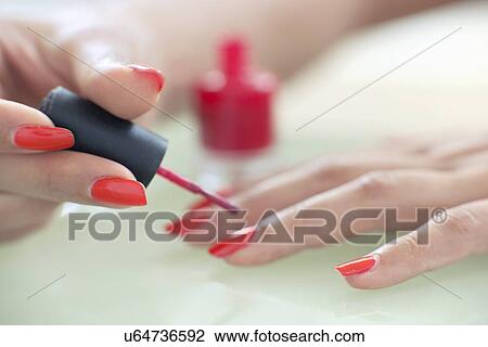 Woman painting her nails View Large Photo Image Stock Image - Woman painting her nails. Fotosearch