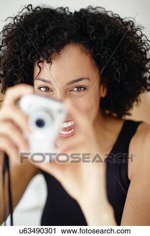Woman taking a photograph View Large Photo Image Stock Image - Woman taking a photograph. Fotosearch
