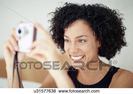 Stock Photo - Woman taking a photograph. Fotosearch