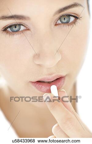 Stock Photo - Woman taking medication. Fotosearch