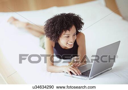 Woman using a laptop View Large Photo Image Stock Image - Woman using a laptop. Fotosearch