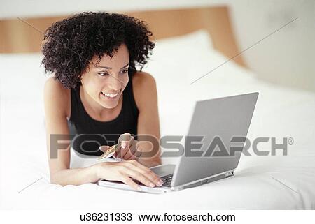 Woman using a laptop View Large Photo Image Stock Image - Woman using a laptop. Fotosearch