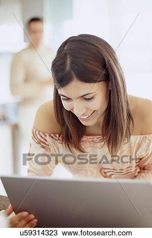 Stock Image - Woman using a laptop. Fotosearch