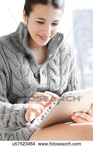 Woman using a tablet computer View Large Photo Image Picture - Woman using a tablet computer. Fotosearch