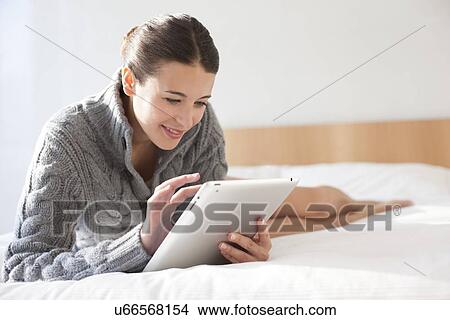 Woman using a tablet computer View Large Photo Image Picture - Woman using a tablet computer. Fotosearch