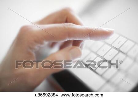 Picture - Woman using a tablet computer. Fotosearch