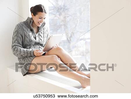 Woman using a tablet computer View Large Photo Image Stock Image - Woman using a tablet computer. Fotosearch