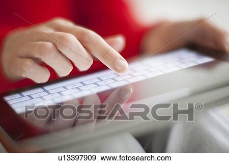 Woman using a tablet computer View Large Photo Image Stock Photo - Woman using a tablet computer. Fotosearch