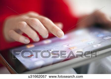 Woman using a tablet computer View Large Photo Image Stock Photo - Woman using a tablet computer. Fotosearch