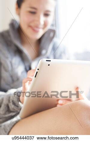 Stock Photo - Woman using a tablet computer. Fotosearch