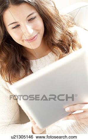Woman using a tablet computer View Large Photo Image Stock Photograph - Woman using a tablet computer. Fotosearch