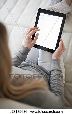 Stock Photograph - Woman using a tablet computer. Fotosearch