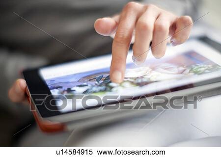 Stock Photography - Woman using a tablet computer. Fotosearch