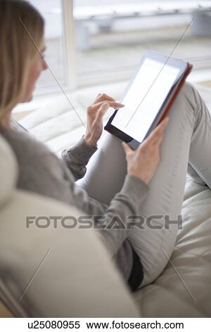 Woman using a tablet computer View Large Photo Image Stock Photography - Woman using a tablet computer. Fotosearch