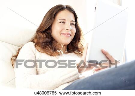 Woman using a tablet computer View Large Photo Image Stock Photography - Woman using a tablet computer. Fotosearch