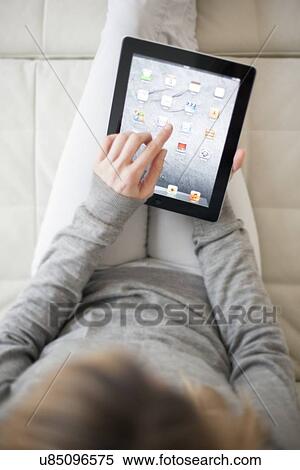 Woman using a tablet computer View Large Photo Image Stock Photography - Woman using a tablet computer. Fotosearch