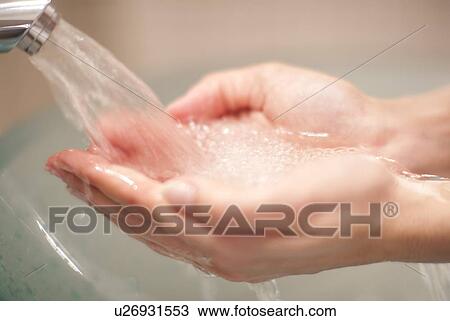 Stock Image - Woman washing her hands. Fotosearch