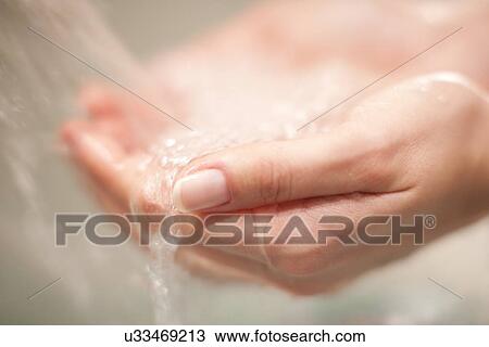 Stock Image - Woman washing her hands. Fotosearch