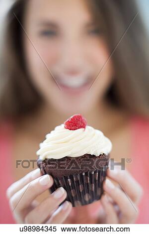 Woman with a cup cake View Large Photo Image Stock Photography - Woman with a cup cake. Fotosearch