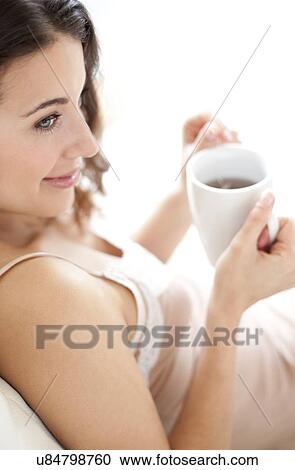 Stock Image - Woman with a hot drink. Fotosearch