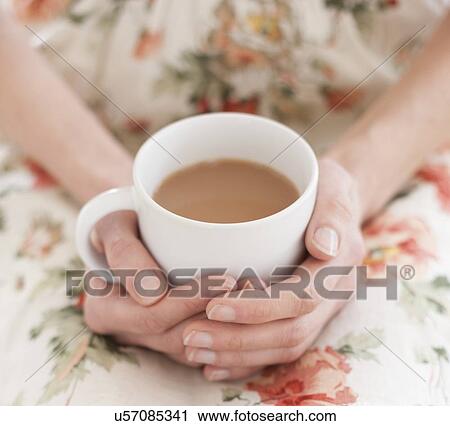 Stock Image - Woman with hot drink. Fotosearch