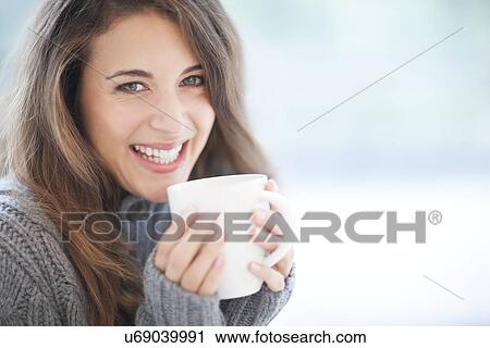 Woman with hot drink View Large Photo Image Stock Image - Woman with hot drink. Fotosearch