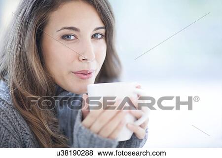 Woman with hot drink View Large Photo Image Stock Photo - Woman with hot drink. Fotosearch