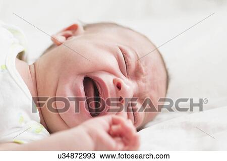 Stock Image - Baby boy (2-5 months) crying. Fotosearch
