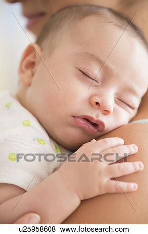 Baby boy (2-5 months) sleeping on mother's shoulder View Large Photo Image Stock Photo - Baby boy (2-5 months) sleeping on mother's shoulder. Fotosearch