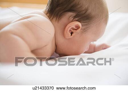 Stock Image - Baby girl (2-5 months) crawling. Fotosearch
