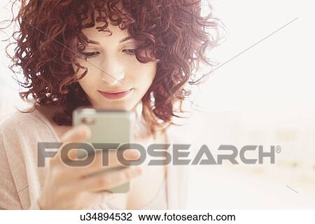 Beautiful brunette woman text messaging View Large Photo Image Stock Image - Beautiful brunette woman text messaging. Fotosearch