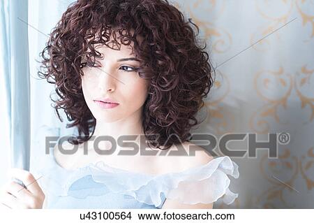 Beautiful woman looking through window View Large Photo Image Picture - Beautiful woman looking through window. Fotosearch