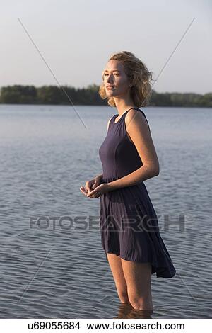 Beautiful woman standing in lake View Large Photo Image Picture - Beautiful woman standing in lake. Fotosearch